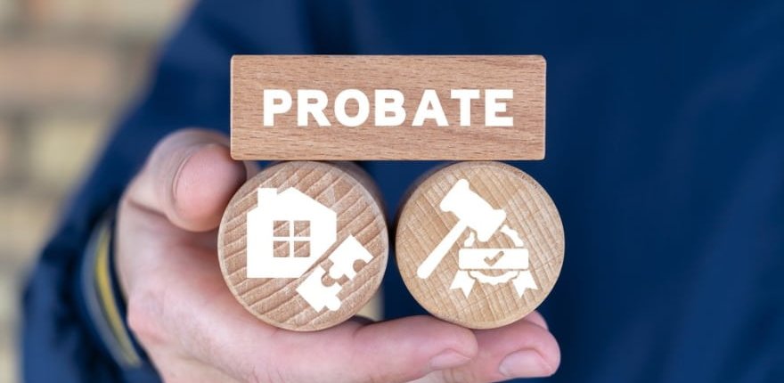 Hand holding wooden blocks labeled "PROBATE," featuring icons of a house and a gavel, symbolizing asset distribution in the Texas probate process.
